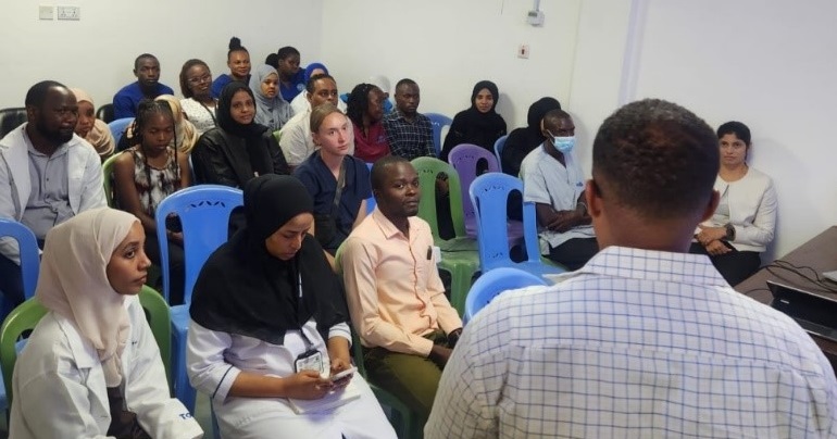 Oncologist Team from Coast General Hospital listening to the presentation