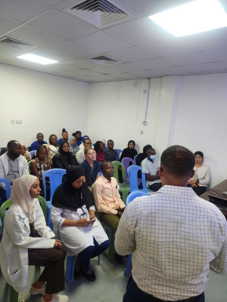 Oncologist Team from Coast General Hospital listening to the presentation
